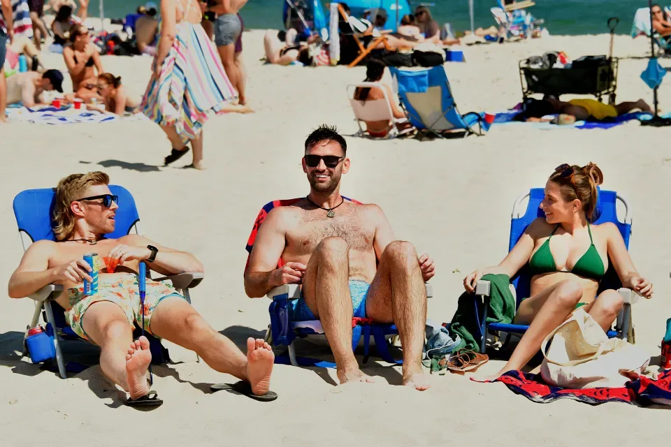 Friends relaxing on a busy beach